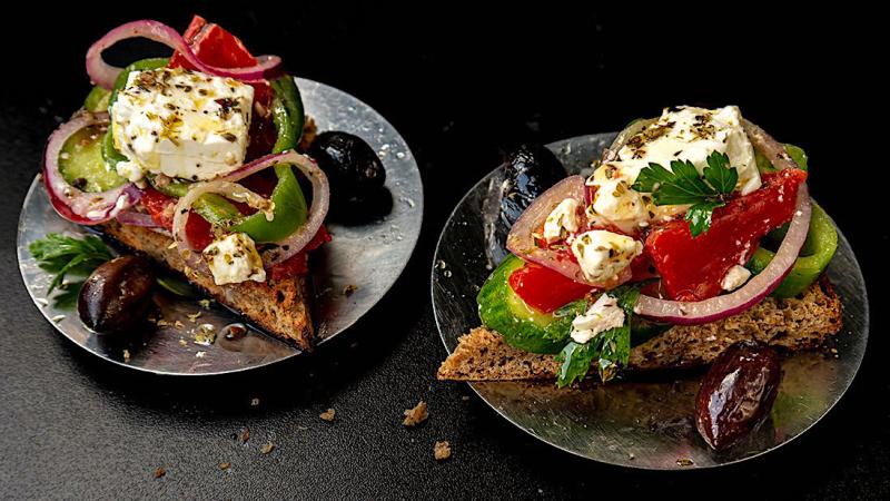 rustic greek “choriatiki” salad slices on flatbread rusks
